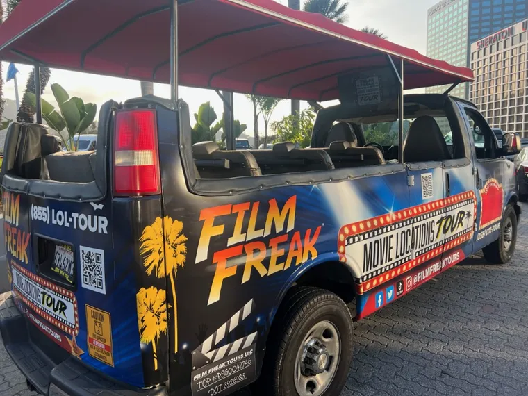 The Film Freak Movie Locations Tour van — custom-wrapped with Film Freak branding, complete with a big-screen TV inside for movie clips
